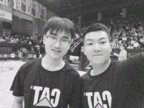 Yinghao Tang with a friend beside a basketball court
