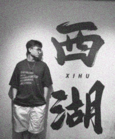 Yinghao Tang standing beside a West Lake sign