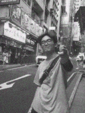 Yinghao Tang walking on a street in Hong Kong