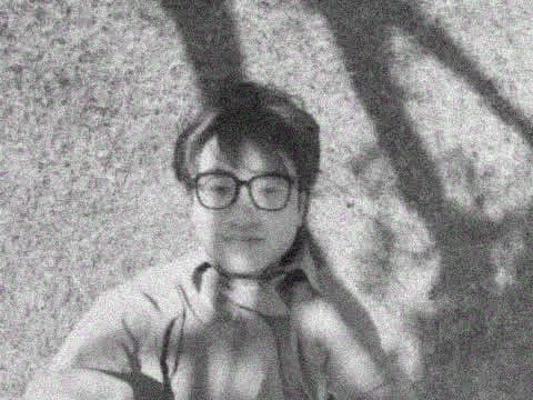 Yinghao Tang lying in the grass